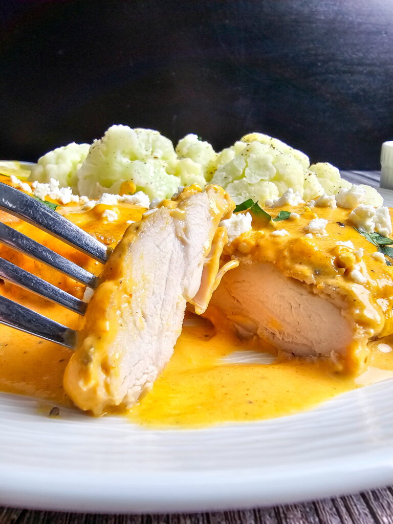 Golden seared chicken thighs in silky roasted red pepper cream sauce finished with goat cheese