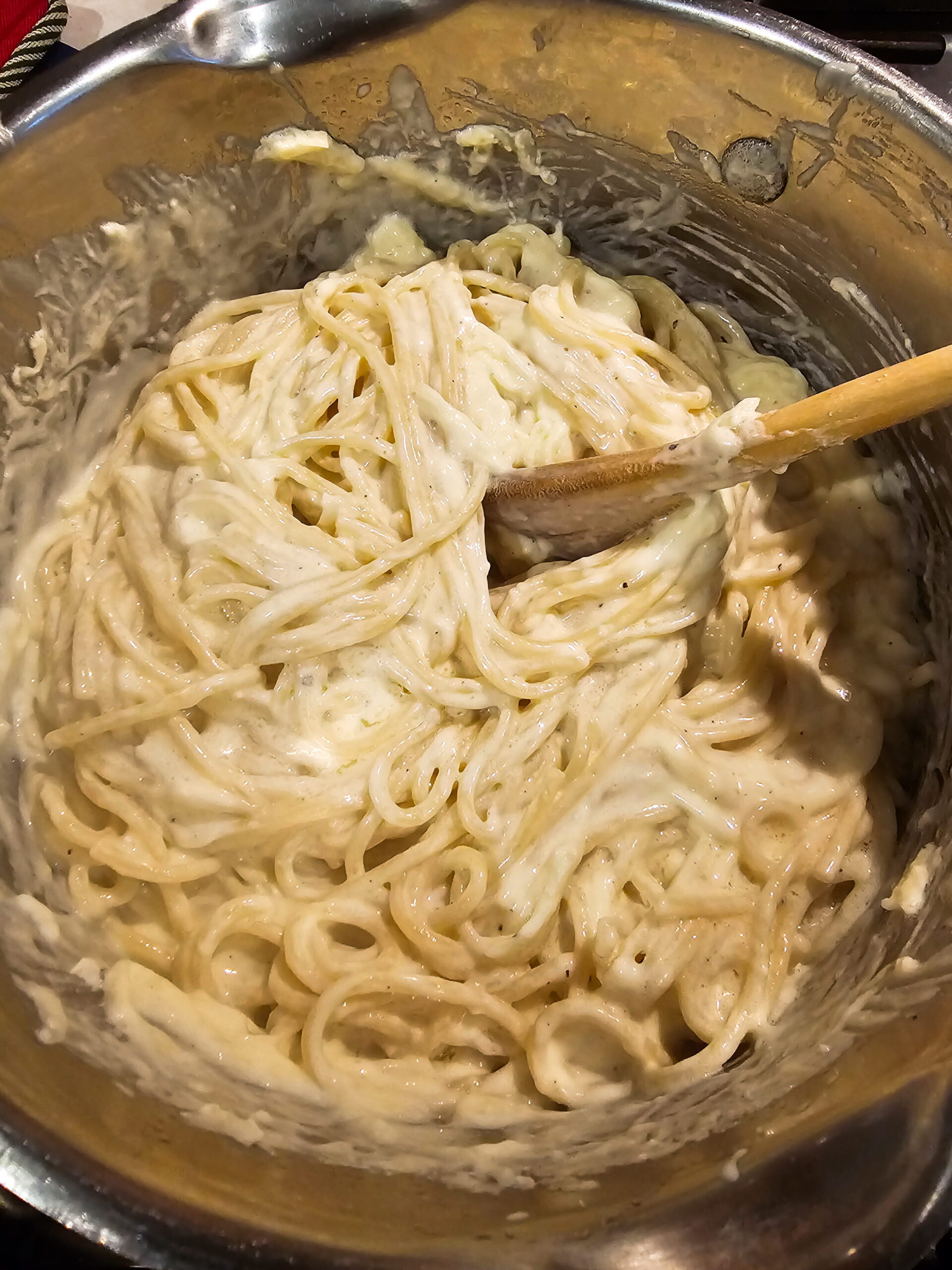 Spaghetti tossed with homemade Alfredo sauce and mozzarella before going into the baking dish