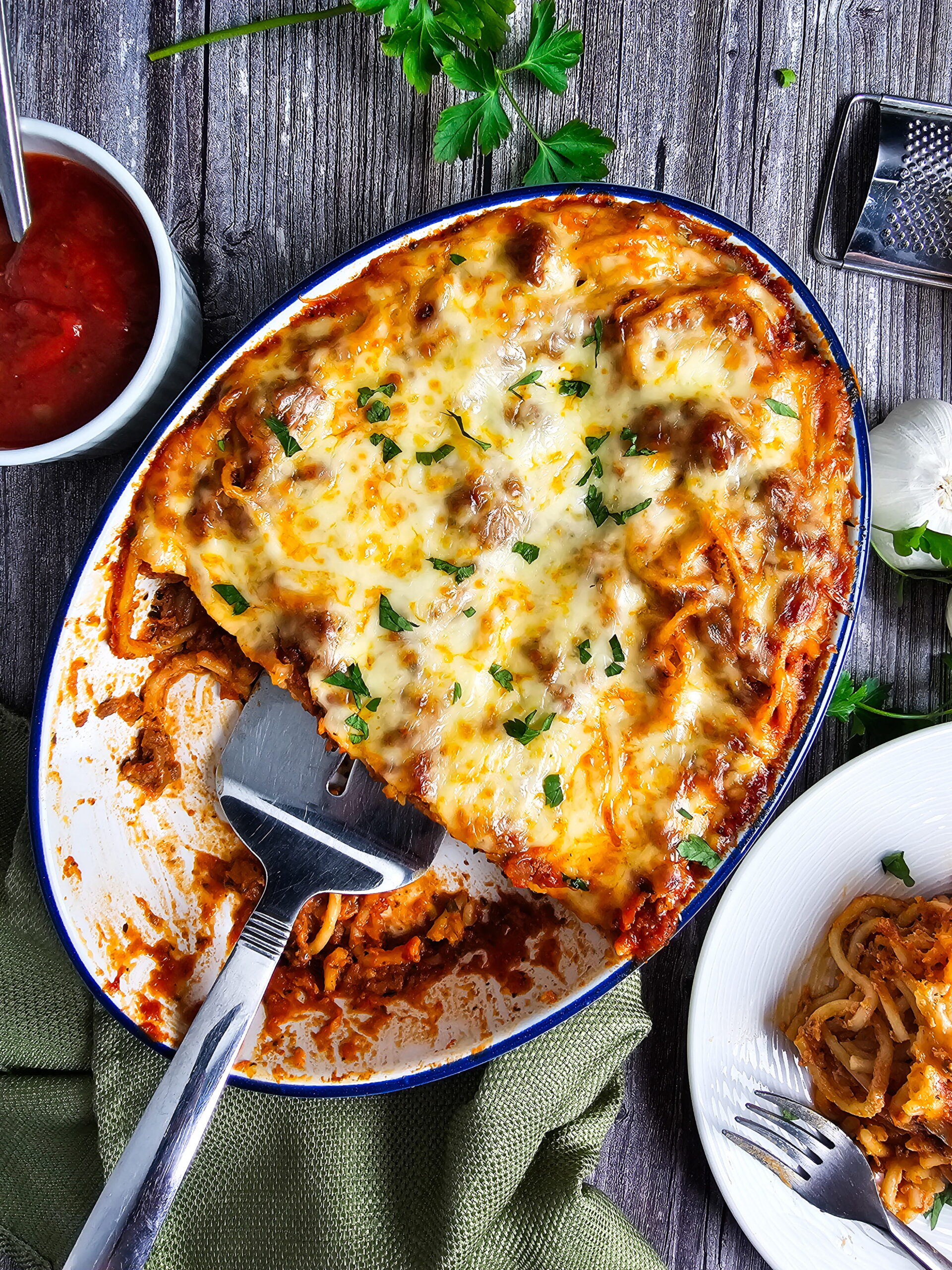 Baked spaghetti with Alfredo sauce fresh from the oven bubbly and golden on top