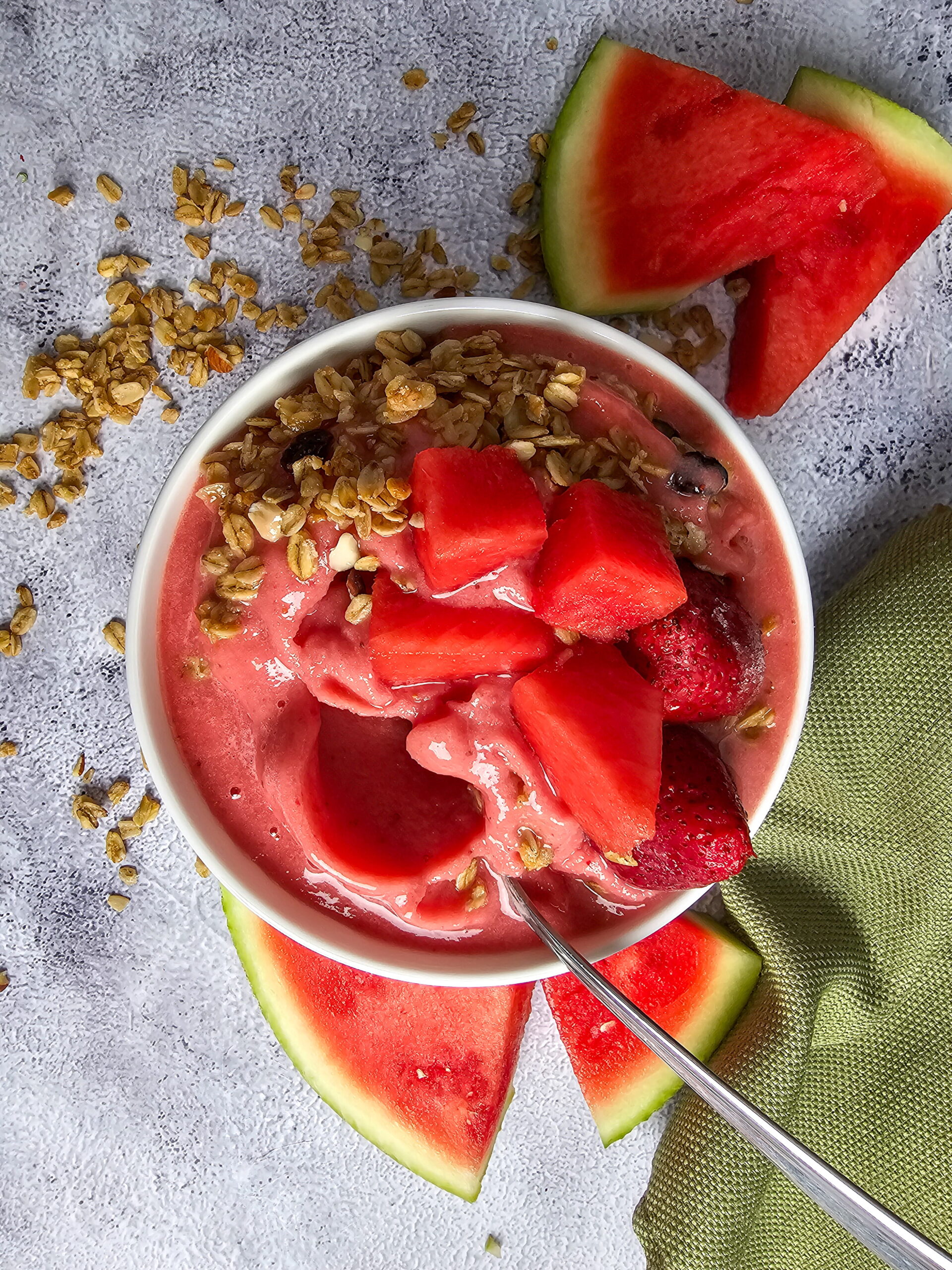 serve the strawberry watermelon smoothie bowl and garnish with granola and fresh fruit