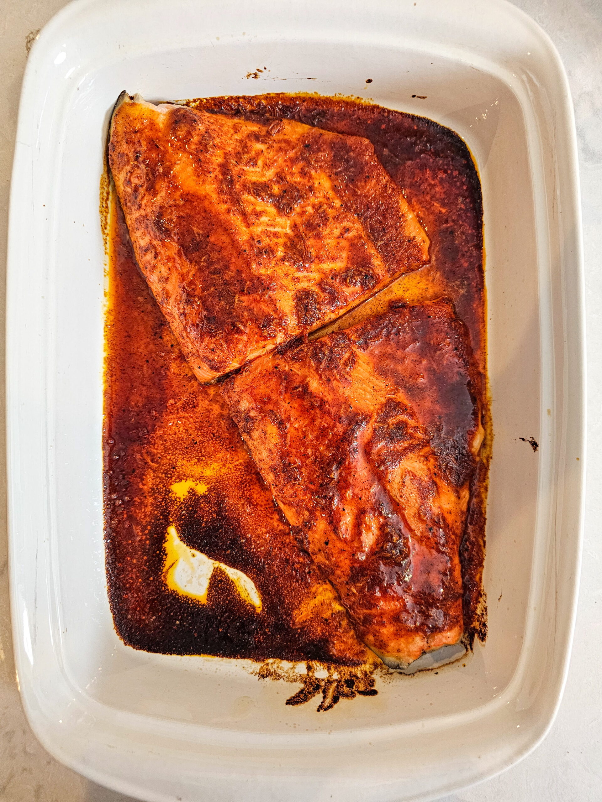 Glazed chili lime trout fillets baking on a sheet pan at 400 degrees Fahrenheit in the oven