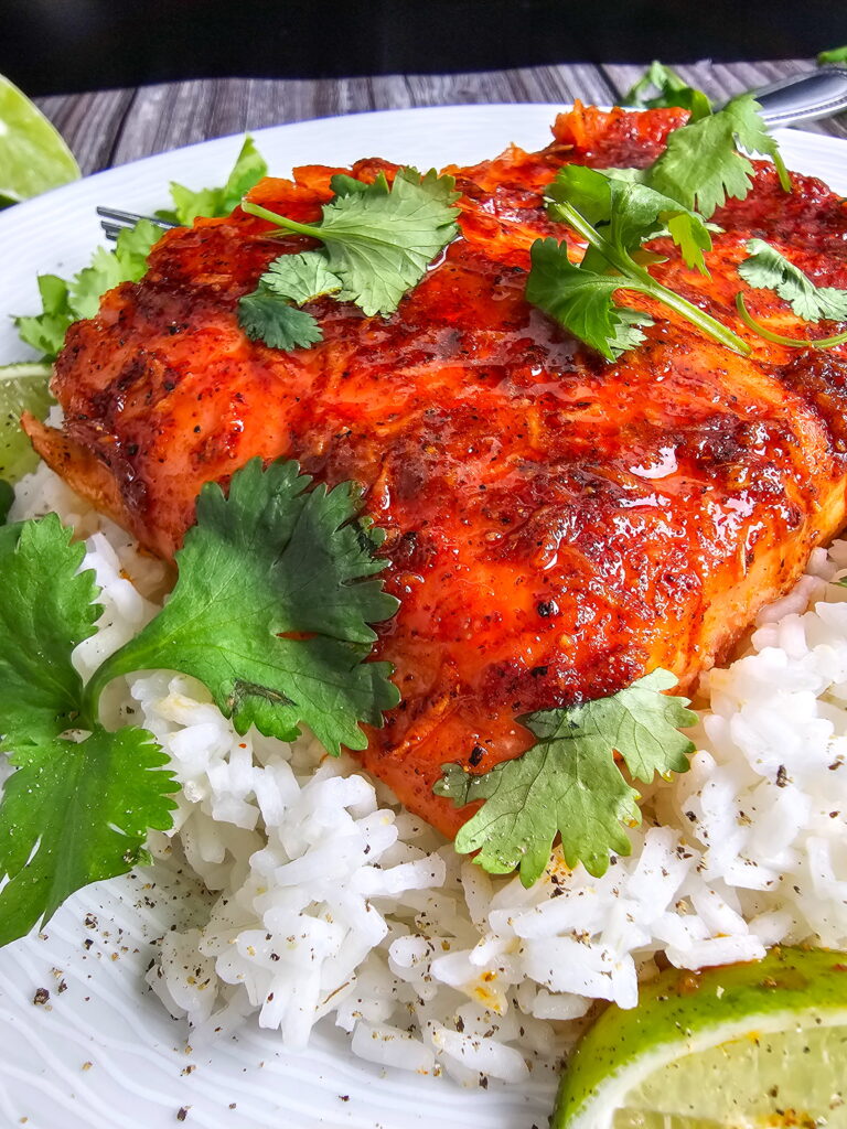 Close-up of chili lime baked trout with caramelized broiled glaze showing golden edges and glossy honey finish